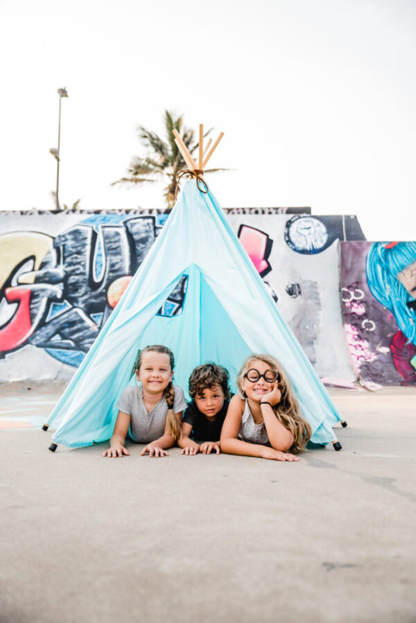 kids inside teepee play tent at skatepark graffiti