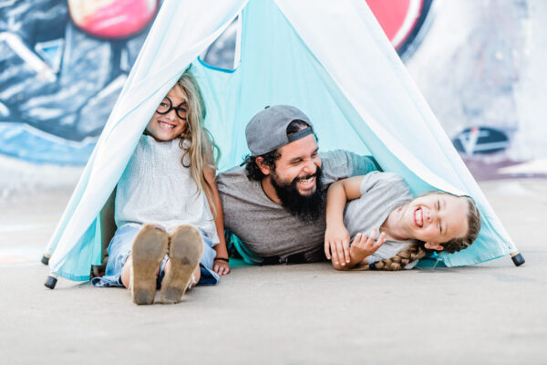 family inside blue teepee play tent